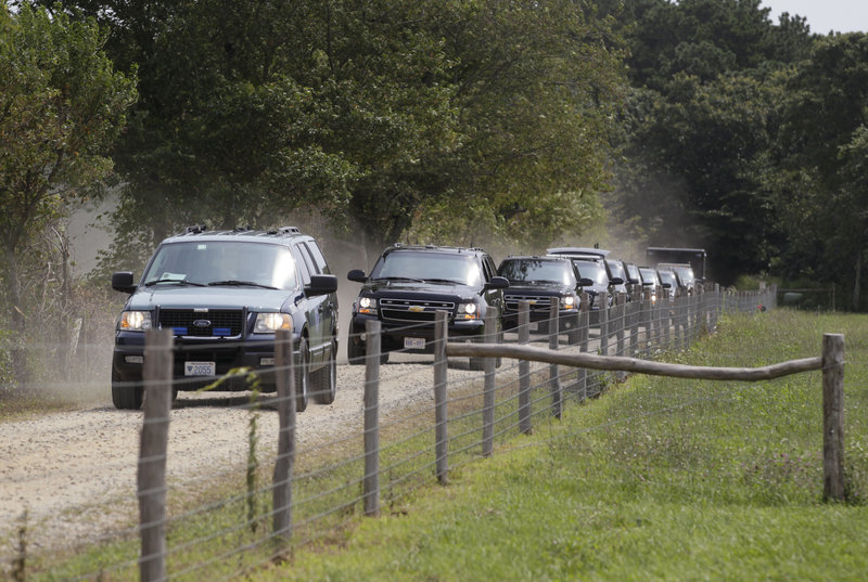 The president’s motorcade leaves the Blue Heron Farm in Chilmark, Mass., on Friday. The White House defends his desire for time to recharge and spend time with his family.