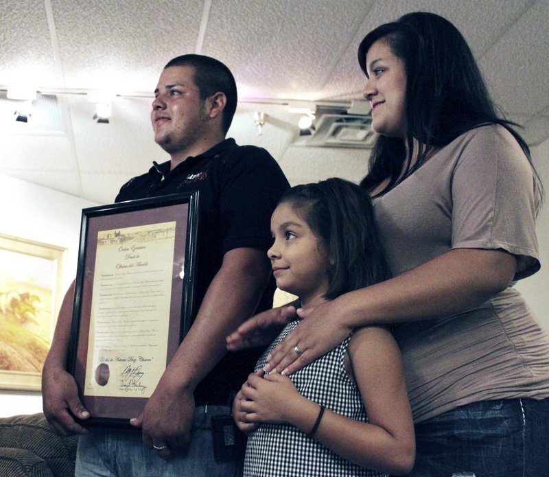 Antonio Diaz Chacon poses with his wife, Martha, and their daughter Brisseida after he was recognized for his heroism during a ceremony in Albuquerque, N.M., on Friday.
