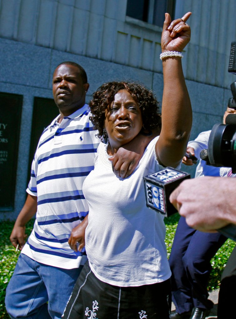 Ablene Cooper and her son Antonio Cooper leave a courthouse in Jackson, Miss., after her lawsuit against “The Help” author Kathryn Stockett was dismissed last week.