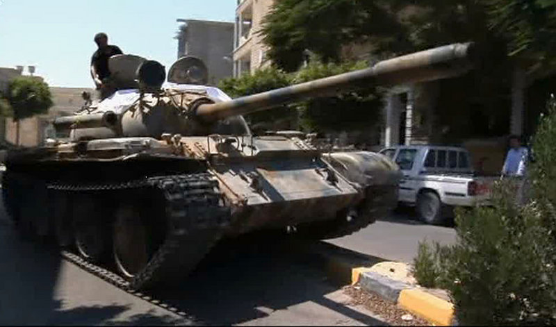 Rebels maneuver a captured tank in Zawiya, Libya, on Friday as they battled troops loyal to Moammar Gadhafi to gain control of the strategic central square in the city.
