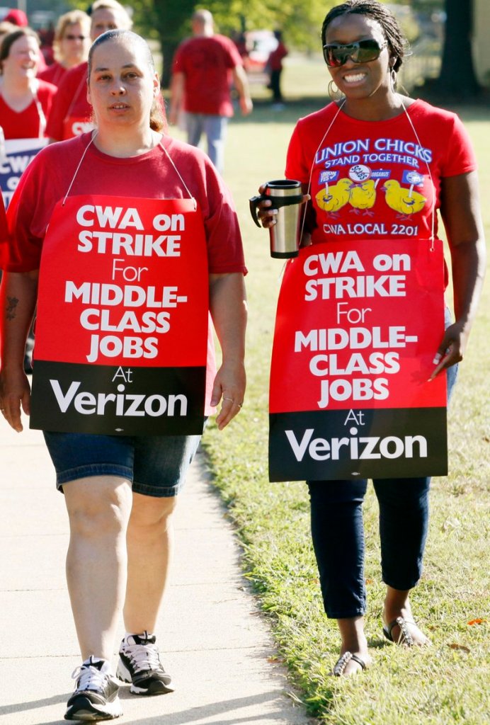 Verizon strikers Crissy Carneal and Nikki Robinson walk the picket line Aug. 8 in Henrico County, Va. The strike involved employees in nine states.