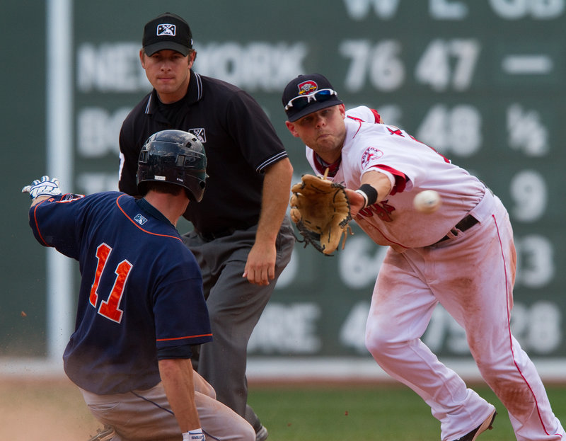 Ryan Khoury of the Portland Sea Dogs takes the throw Saturday as Jon Malo of the Binghamton Mets slides into second base with a ninth-inning double at Fenway Park. Malo didn t score, but Binghamton came away with a 6-4 victory in 11 innings.