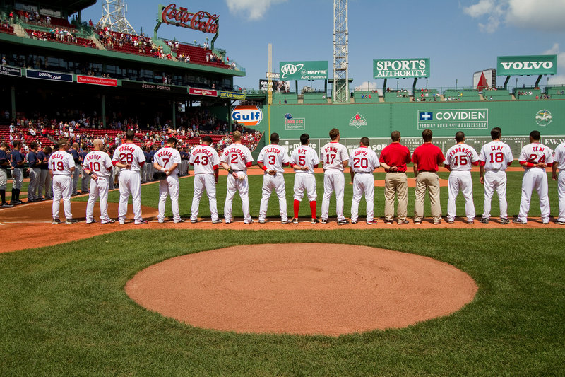The Portland Sea Dogs line up along the first-base line Saturday for the national anthem at Fenway Park prior to the game against the Binghamton Mets. Binghamton came away with a 6-4 victory in 11 innings.