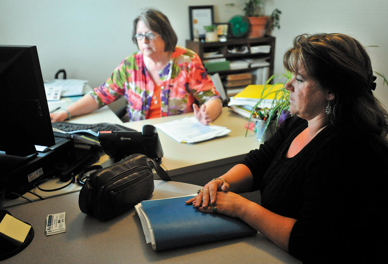 Carol Homer, a homeownership support counselor, center, discusses mortgage options with Lynne Choate, 35, of Winslow at the Kennebec Valley Community Action Program office in Waterville.