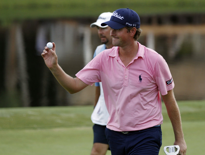 Webb Simpson acknowledges the crowd after sinking a 5-foot eagle putt on the 15th hole during the third round of the Wyndham Championship at Greensboro, N.C. Simpson shot a 6-under 64 to pull into a two-stroke lead.