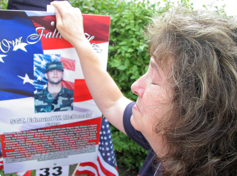Kathy McDonald of Casco has a moment of silence for her son Sgt. Edmund W. McDonald, who was killed while in service in Kabul, Afghanistan, on March 28, 2007. The family gathered on Route 1 in Saco on Sunday to thank runners and to run themselves.