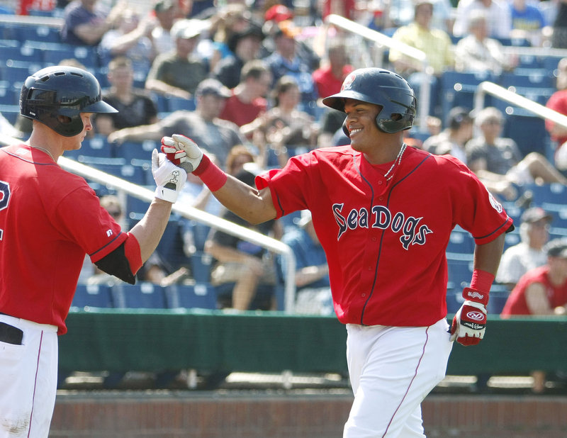 Jeremy Hazelbaker, left, greets Reynaldo Rodriguez at the plate after Rodriguez hit a home run in the bottom of the fourth inning Sunday. Five home runs were recorded Sunday, three by the Sea Dogs, in a 7-6 loss, which capped a three-game series sweep by the Mets.