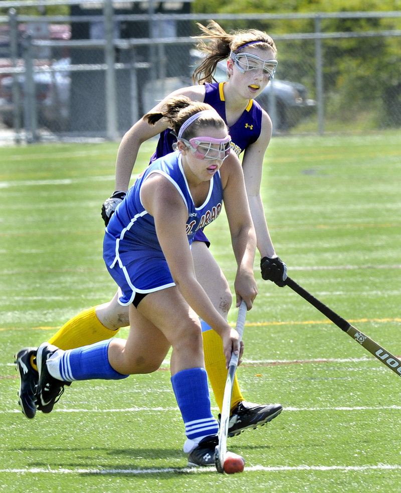 Lindsey Smith of Mt. Ararat carries the ball as Sarah Laquerre of Cheverus defends on Monday in Cape Elizabeth.