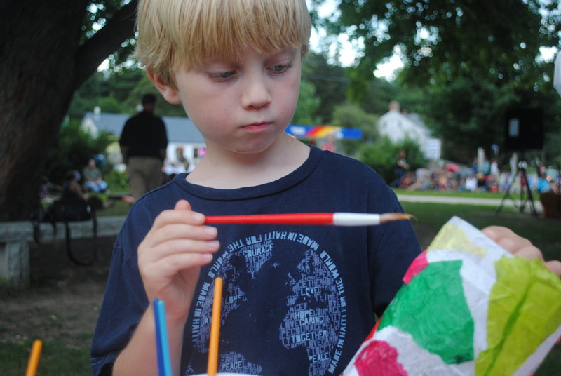 Ashton Gagnon, 7, of Rochester, N.H., makes a paper lantern to be displayed Thursday at LanternFest in South Berwick.