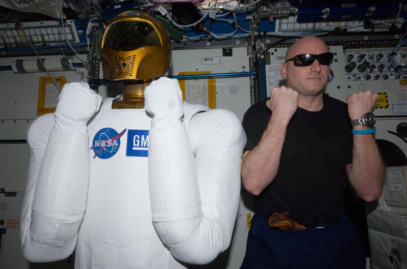 Astronaut Scott Kelly poses with Robonaut 2, the dexterous humanoid astronaut helper, in the Destiny laboratory of the International Space Station earlier this year.