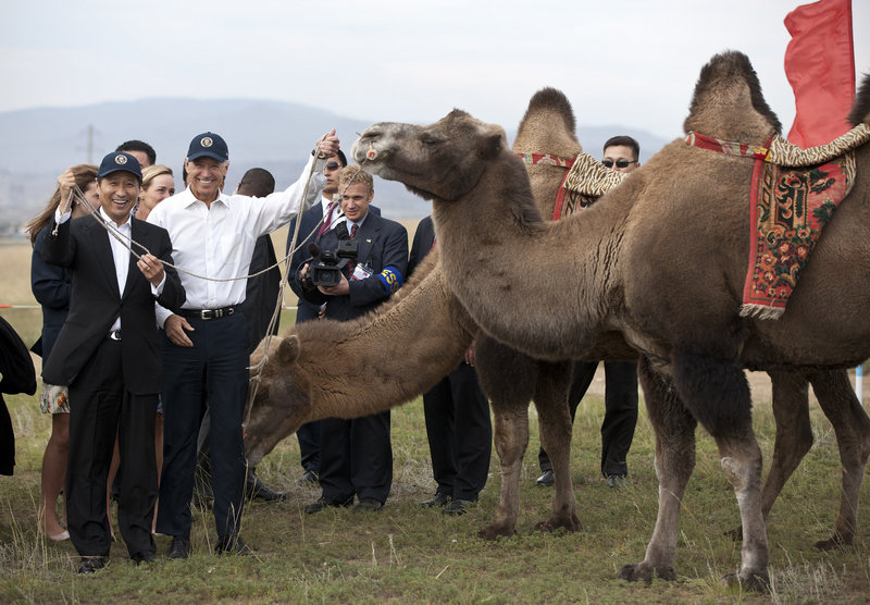 Vice President Joe Biden and Mongolian Prime Minister Sukhbaatar Batbold, left, pose for pictures with camels at a Mongolian wrestling performance in Ulan Bator on Monday.