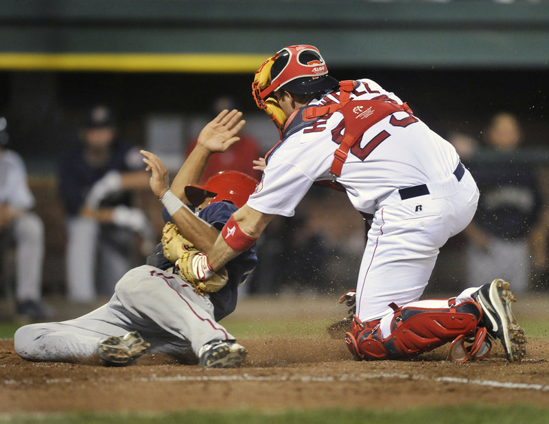 Portland catcher Jeff Howell tags out Josh Johnson of the Senators on a throw from first baseman Jon Hee in the sixth inning Monday night.