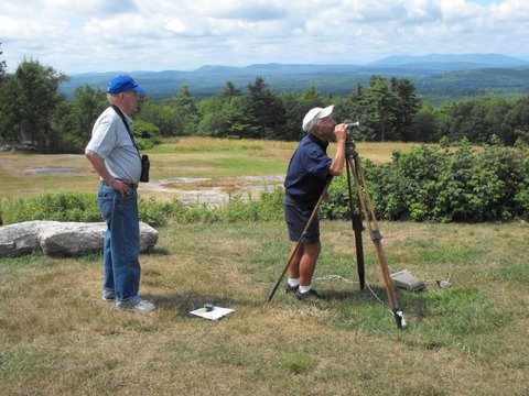 Dick Anderson and Earl Raymond use a surveying instrument at Hacker’s Hill to identify the landforms and mountain ranges and piece together the geological history of the landscape. A geology walk and talk will be held Tuesday from 5:30 to 6:30 p.m. Rain date is Thursday.