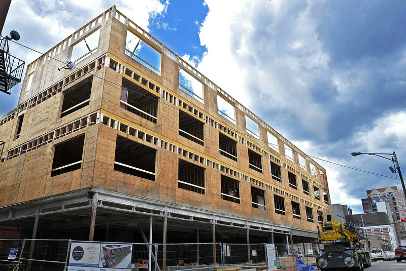 Work continues Tuesday at the Oak Street Loft Apartments in downtown Portland just off Congress Street. The four-story, $6.4 million building will have 37 energy-efficient apartments and community space with gallery potential on the ground floor. It’s expected to open in December.