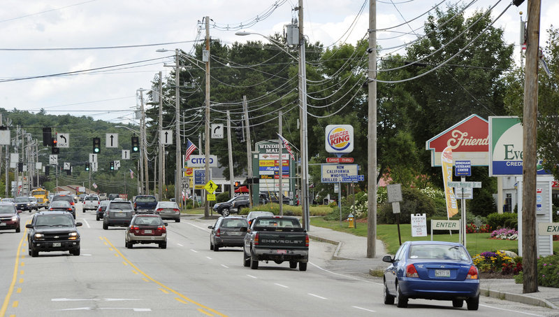 Traffic moves along Route 302 in North Windham. The Planning Board wants to see downtown buildings with pitched roofs, landscaped parking lots, and brick walls, clapboard siding or shingles.