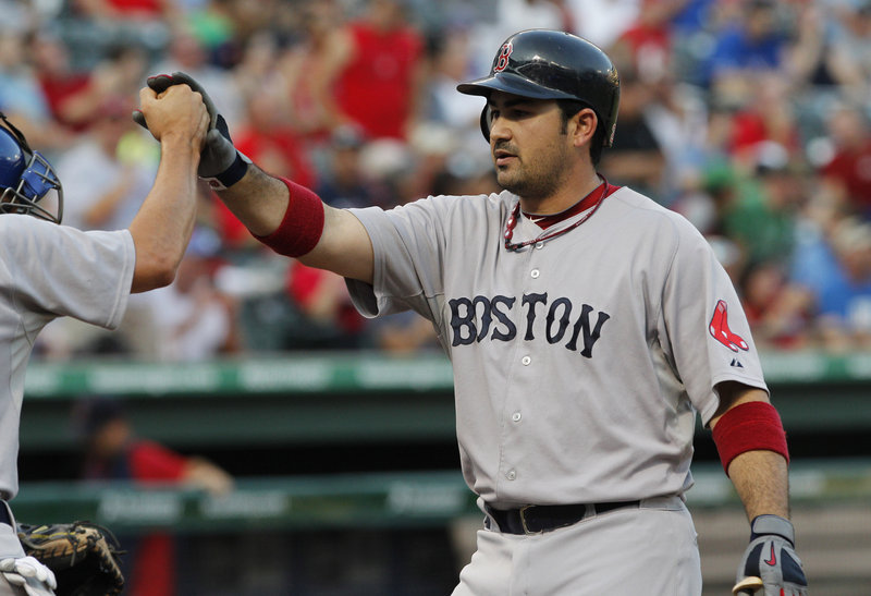 Adrian Gonzalez is greeted at home plate after hitting the first of his two home runs for the Red Sox. This one also scored Jacoby Ellsbury.