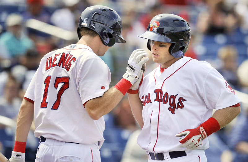 Jeff Howell, right, of the Portland Sea Dogs is congratulated by teammate Mitch Dening after hitting a fourth-inning home run with nobody on at Hadlock Field.