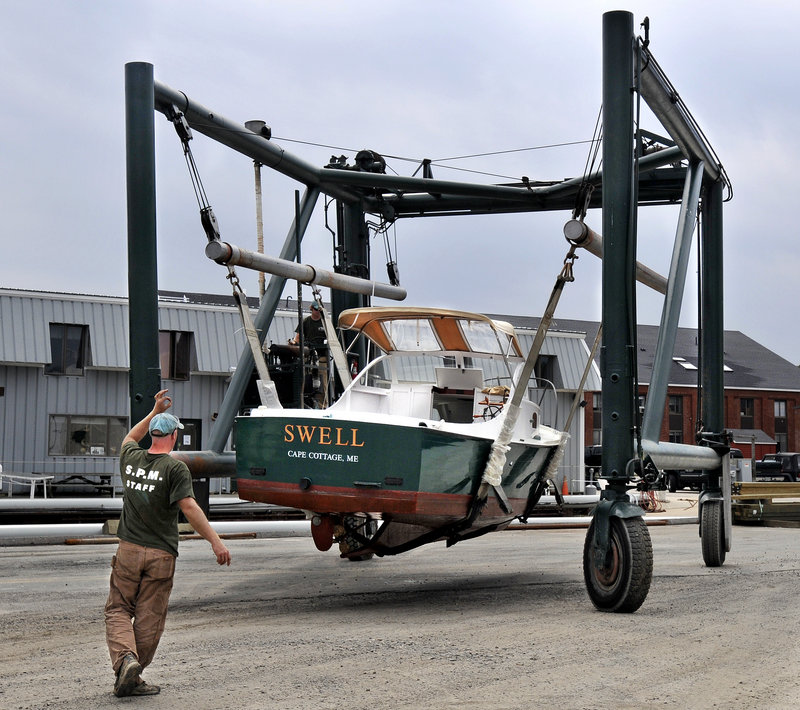 Crews at South Port Marine in South Portland stayed busy Thursday hauling boats from Portland Harbor in advance of the battering winds and surf expected from Hurricane Irene.