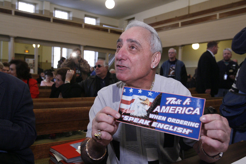 Joey Vento, owner of Geno’s Steaks in Philadelphia, displays a sign during a recess of a Commission on Human Relations hearing in Philadelphia in this Dec. 14, 2007, file photo.