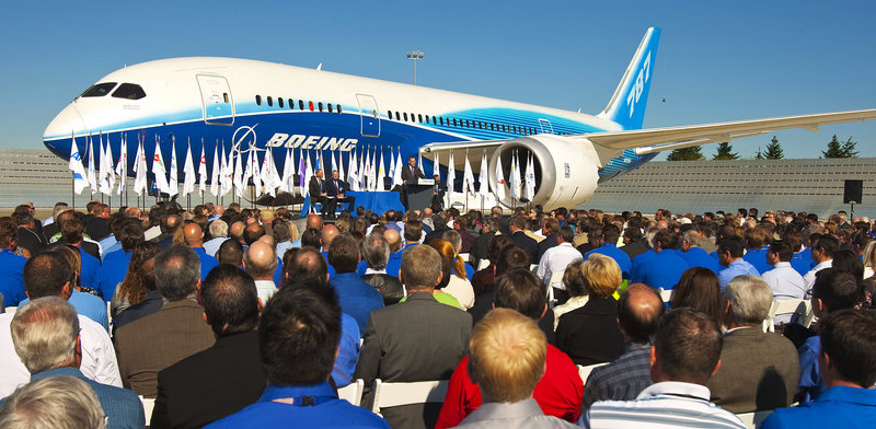 Speakers announce Federal Aviation Administration certification of the Boeing 787 for commercial flight on Friday in Everett, Wash., with the first 787 providing the backdrop.
