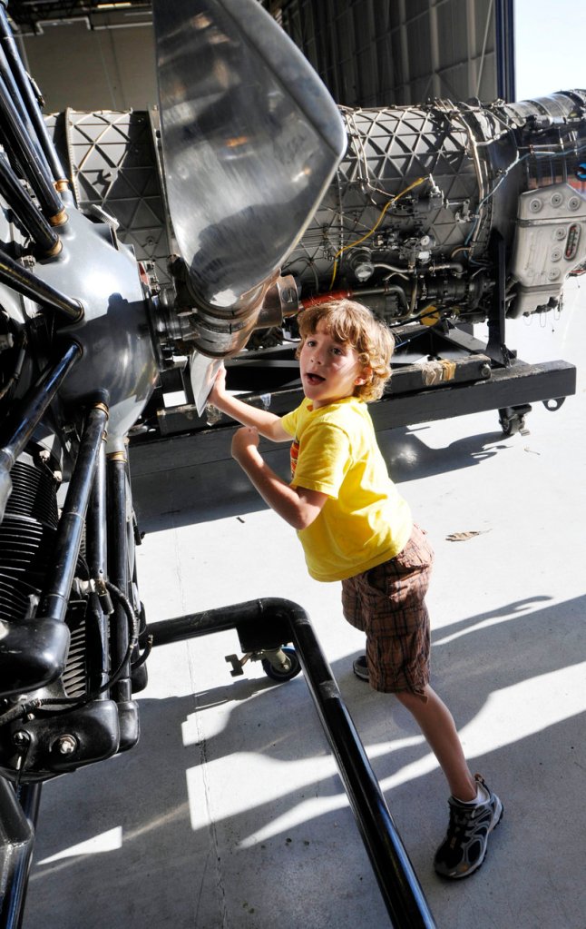 C.J. Stafford, 6, of Portland turns a Hamilton Standard Propeller on display at the Great State of Maine Air Show at the former Brunswick Naval Air Station on Friday.