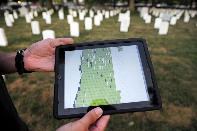 Army Spc. Matthew Caruso shows the Apple iPad and spreadsheet that is used to keep track of which headstones the Old Guard has photographed. Caruso said, “it’s a good feeling” to do the work, “but it can be pretty stressful.”