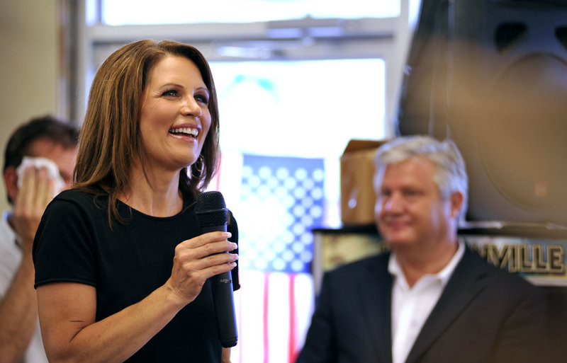 Presidential hopeful Michele Bachmann speaks to supporters Friday at Angie’s Subs in Jacksonville Beach, Fla. At right is her husband, Marcus Bachmann.