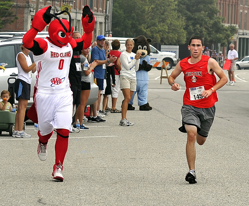 No, Crusher the Maine Red Claws mascot wasn't entered in the race, but he was on the sidelines to encourage Nate DiMartino as he heads to the finish line.