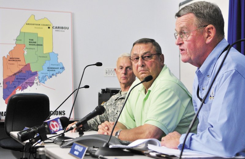 Maj. Gen. John W. “Bill” Libby, commissioner of the Department of Defense, Veterans and Emergency Management, left, and Gov. Paul LePage listen as Maine Emergency Management Agency Director Robert McAleer talks about Hurricane Irene during a news conference on Saturday at the MEMA headquarters in Augusta.