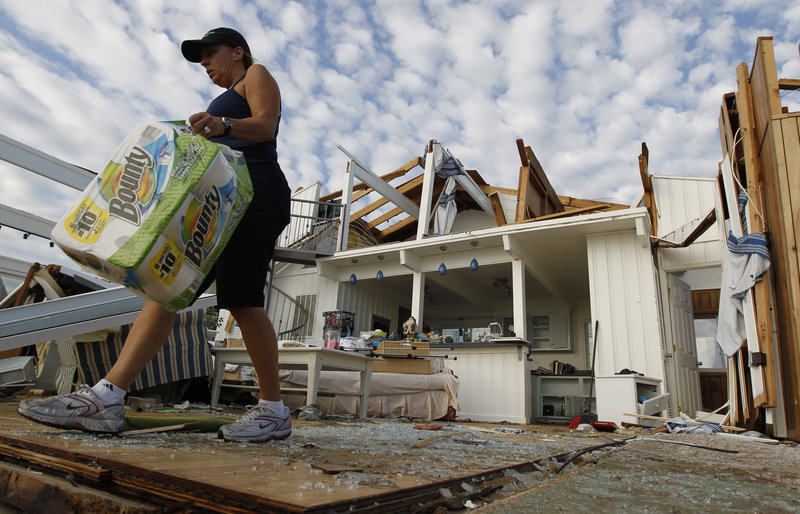 Denise Robinson clears out her destroyed beach home in Virginia Beach, Va., on Sunday after Hurricane Irene struck. Officials speculate that a tornado swept through.