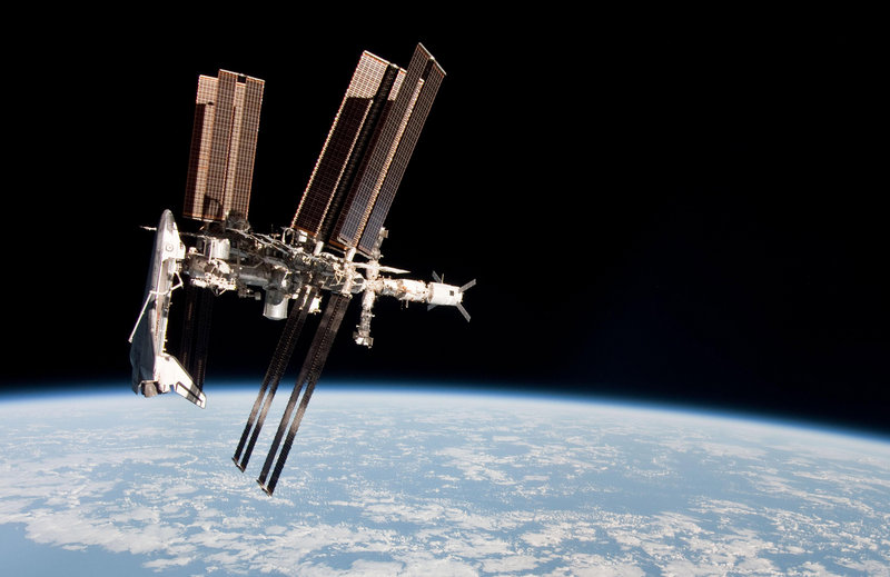 Photo taken by crew member Paolo Nespoli from the Soyuz spacecraft shows the International Space Station and the docked space shuttle Endeavour, at left, last May.
