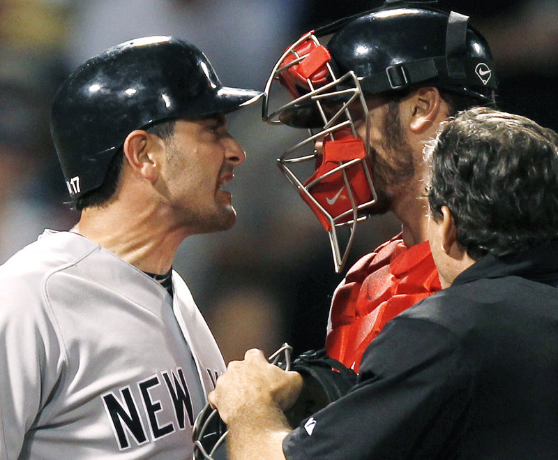 Francisco Cervelli of the Yankees jaws with Red Sox catcher Jarrod Saltalamacchia after getting hit by a John Lackey pitch in the seventh inning Tuesday night at Fenway Park.