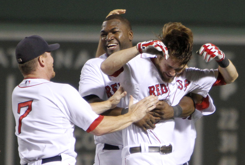 Boston's J.D. Drew, David Ortiz and Josh Reddick celebrate Reddick's RBI single that gave the Red Sox a walk-off 3-2 win against the New York Yankees in the 10th inning Sunday.
