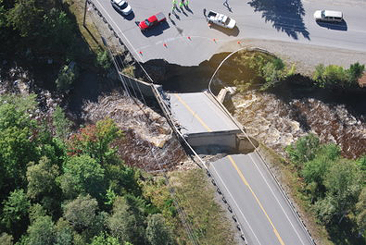 A bridge on Route 27 near the entrance to Sugarloaf ski resort shows flood damage from Tropical Storm Irene on Monday.