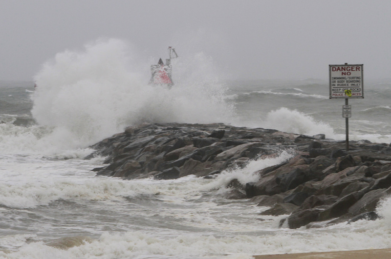 Waves and wind from Hurricane Irene pound the Rudee inlet jetty in Virginia Beach , Va., today.