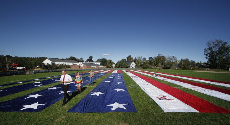 A half-acre section of the Heart of America Quilt is displayed outside Freeport High School on Saturday. The quilt, which was started in Maine and includes signatures and messages from all 50 states and 14 countries, honors victims of the 9/11 attacks and serves as a symbol of national unity. More in today’s Special section: "Remembering 9/11"