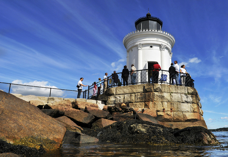 People mill around Bug Light in South Portland today for Open Lighthouse Day. The state opened access to a variety of lighthouses up and down the coast.