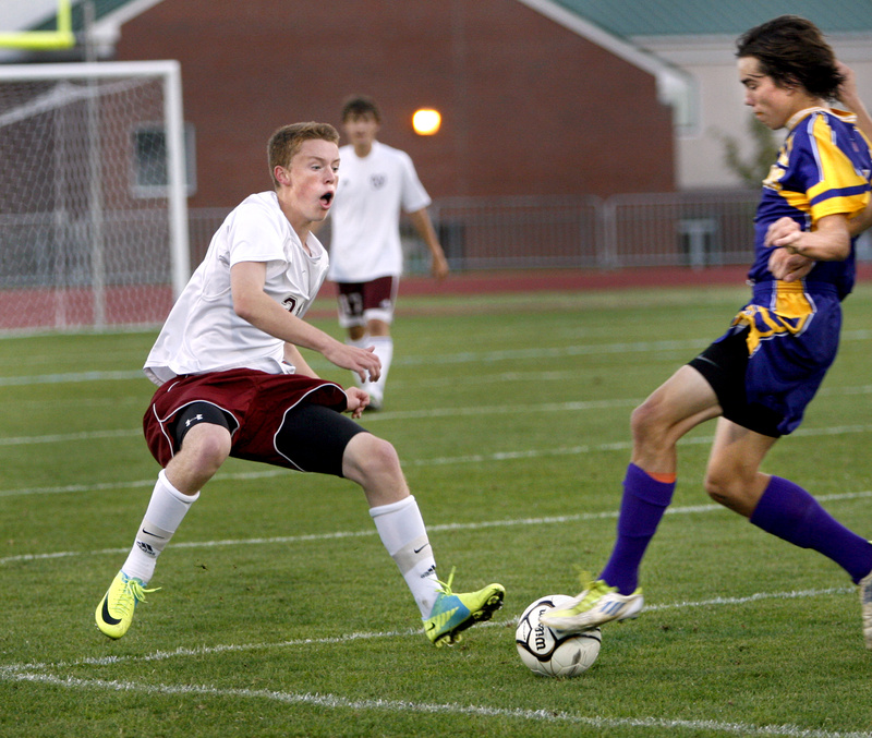 Elliot Maker of Cheverus High School, right, gains control of the ball as Christian Hewitt of Windham High School attempts to slow Maker down during Cheverus’ 2-0 victory in a boys’ soccer game Tuesday.