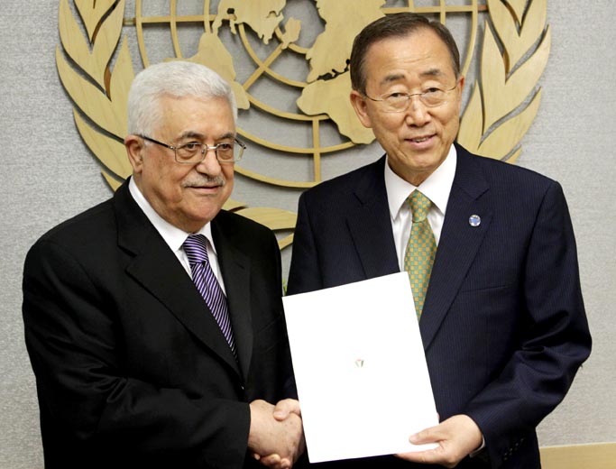 Palestinian President Mahmoud Abbas, left, poses with Secretary-General Ban Ki-moon after giving him a letter requesting recognition of Palestine as a state at United Nations headquarters today.