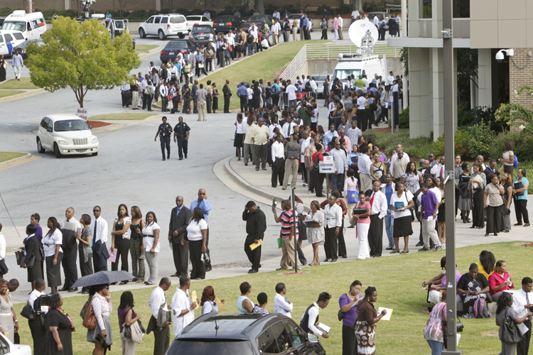 In this Aug. 18, 2011, photo, people wait in line during a job fair, sponsored by the Congressional Black Caucus, on the campus of Atlanta Technical College in Atlanta. Economists no longer think the economy's troubles are fleeting. Their gloominess reflects expectations that slow growth, high unemployment and weak consumer spending will persist into next year.