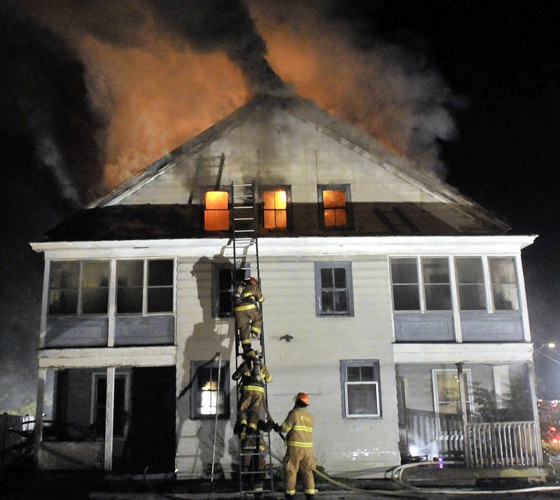 Staff photo by Michael G. Seamans Firefighters from Waterville and WinslowFire Departments responded to a structure fire on Water Street Monday evening. The apartment building was a total loss.