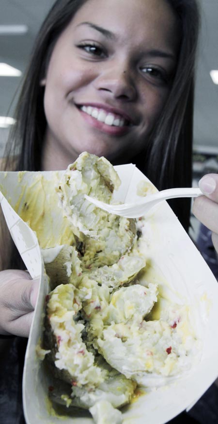 Maria Turner poses with her dish of baked potatoes mixed with sour cream, bacon bits, melted cheese and croutons during lunch at Gardiner High School in Gardiner in this Sept. 14, 2011 photo. New guidelines proposed by the U.S. Department of Agriculture would eliminate potatoes altogether from school breakfasts and drastically reduce the amount of potatoes served in lunches.