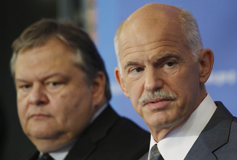 Greek Prime Minister George Papandreou, right, backed by his Finance Minister Evangelos Venizelos, speaks during a news conference in Thessaloniki, Greece on Sunday. Greece's cash-strapped government said Sunday it would impose a new property tax, on top of existing austerity measures, to contain this year's revenue shortfall and achieve a primary surplus in 2012.