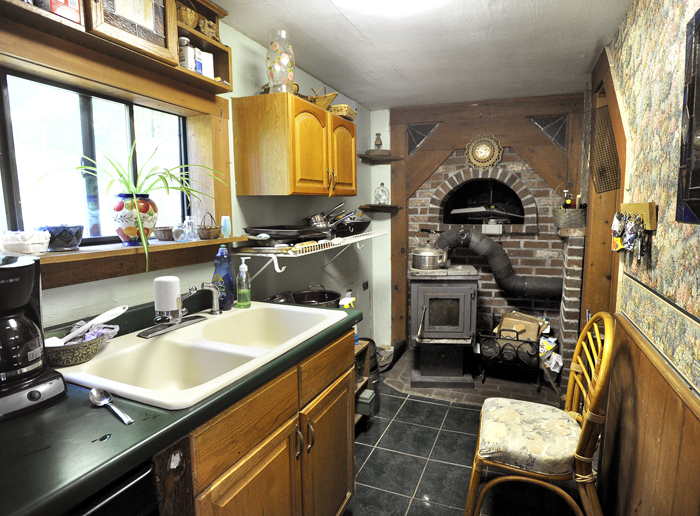 A small wood stove in Michael Mayhew's kitchen supplements solar heat during the colder days.