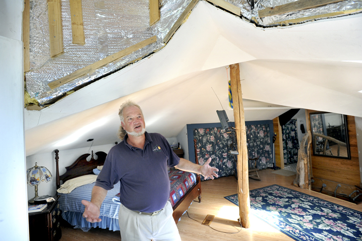 Michael Mayhew is still working on the insulation in the ceiling of his new master bedroom.