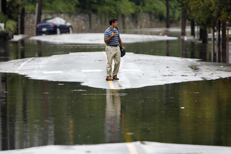A person turns back from crossing floodwaters today in the Manayunk neighborhood of Philadelphia. In Pennsylvania, inundated communities were evacuated today and state offices closed down because of the rising waters.