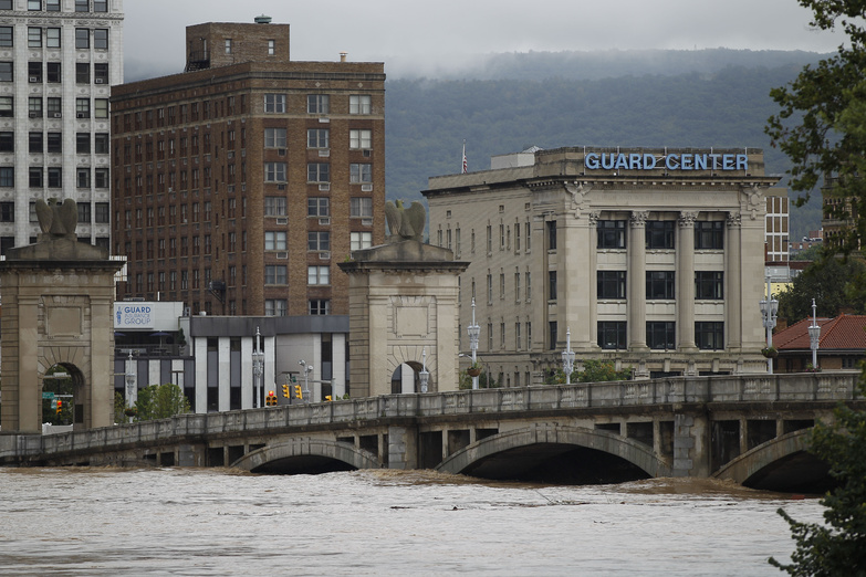 The Susquehanna River rises against a bridge in Wilkes-Barre, Pa., on Thursday during widespread flooding caused by the remnants of Tropical Storm Lee. Up to 9 inches of rain fell in Pennsylvania and parts of New York, closing hundreds of roads and forcing tens of thousands to evacuate. In Wilkes-Barre, the levee system was under duress. “This is a scary situation,” an official said.
