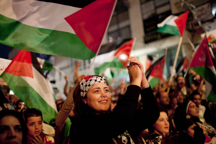 Palestinians in the West Bank city of Ramallah, cheer moments before their president, Mahmoud Abbas, addressed the General Assembly of the United Nations today.
