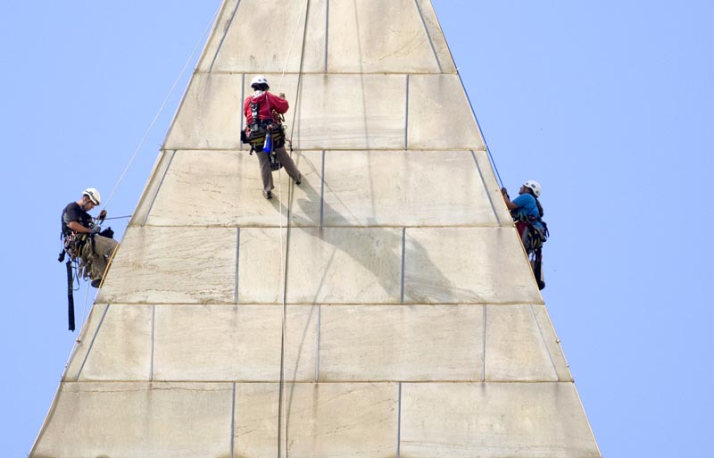 A team of engineers – from left, Dan Gach, Emma Cardini and Katie Francis – inspect the exterior of the Washington Monument for damage caused by last month's earthquake.