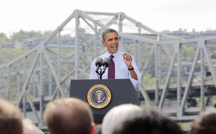 President Barack Obama promotes his American Jobs Act Now legislation today in Cincinnati with the aging Brent Spence Bridge as a backdrop.